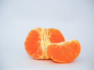 peeled tangerine orange on a white background
