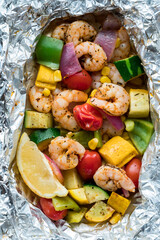 Above close up view of a freshly cooked, ready to eat, shrimp foil packet.