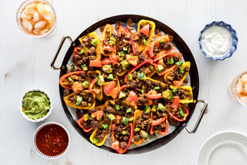 A platter of homemade mini bell pepper nachos hot out of the oven.