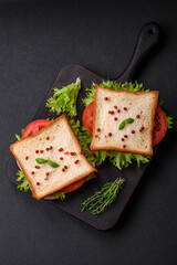 Delicious sandwich with toast, ham, tomatoes, cheese and lettuce