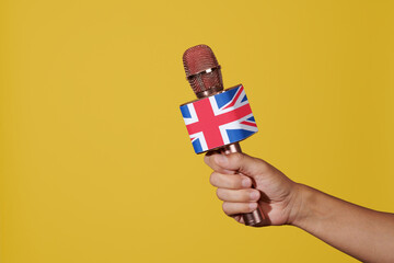 man has a microphone patterned with the flag of UK