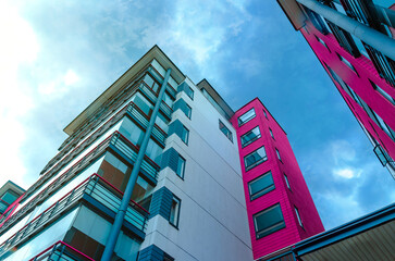 Real estate photo of an apartment building with pink bricks details. A place for living in a city. 