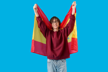 Teenage boy with flag of Spain on blue background