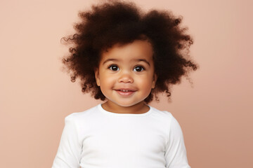 design mockup: cute black baby girl wearing white blank shirt or bodysuit on a pastel brown background, studio shot