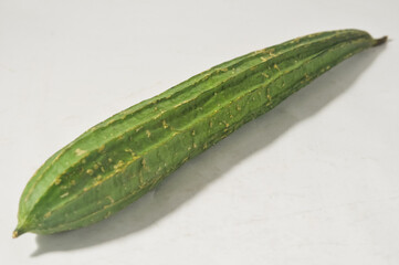 A gambas or luffa gourd isolated on a white background.