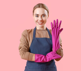 Young woman in rubber gloves on pink background