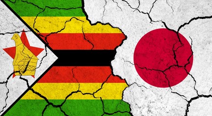 Flags of Zimbabwe and Japan on cracked surface - politics, relationship concept - obrazy, fototapety, plakaty