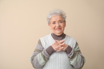 Senior woman on beige background