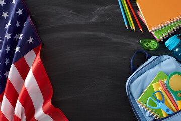 Potential of education in America. Top view flat lay of national flag, school supplies, rucksack, water bottle on blackboard background with empty space for promo or text