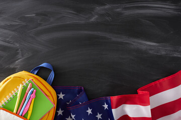 Embracing the back-to-school spirit in USA. Top view shot of american flag, pens, compass, copybook, schoolbag on blackboard background with empty space for promo or text