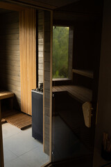 Modern wooden Finnish sauna interior with wooden benches. Wooden interior baths, wooden benches and loungers accessories for sauna, spa complex.