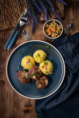 Meatballs with cheese served with boiled potatoes.