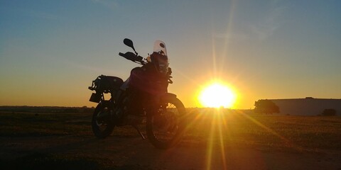 big trail motorcycle, sunset landscape, sun