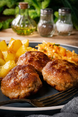 Meatballs  served with fired potatoes.