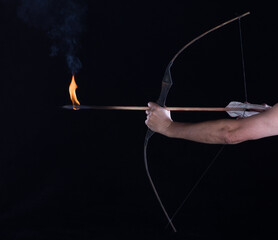 archer shoots a flaming arrow from a bow