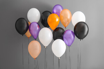 Different Halloween balloons on grey background