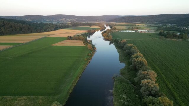 View of the San River bed and flood plain covered with farmland during sunset, Iskań, Przemyskie Foothills, Subcarpathian, Poland