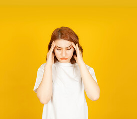 Suffering migraine, portrait of young red hair beautiful  caucasian girl suffering migraine. Hands...