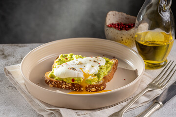 Wholemeal toast with avocado and poached egg.