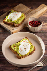 Wholemeal toast with avocado and poached egg.