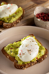 Wholemeal toast with avocado and poached egg.