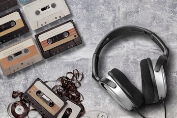 Vintage retro audio cassette and headphones on desk