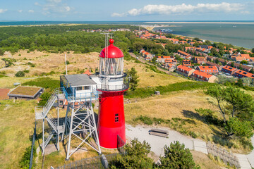 Aerial drone image of the island Vlieland. With bright red lighthouse on top of a sand dune...