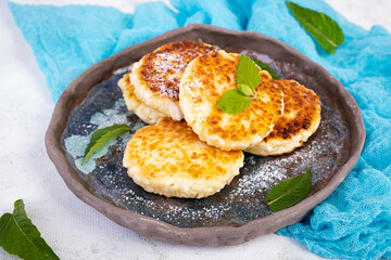 Sweet curd pancakes with mint. Cottage sheese pancakes or syrniki