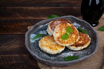 Sweet curd pancakes with mint. Cottage sheese pancakes or syrniki