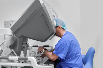 surgeon performing robotic surgery with robotic device. Medical operation involving robot....