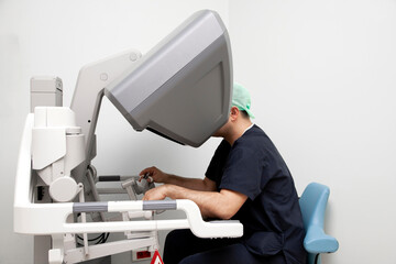 surgeon performing robotic surgery with robotic device. Medical operation involving robot.