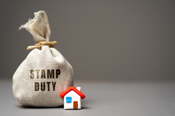 Stamp duty concept. Taxes assessed during the transfer of real estate between two parties. Buying...