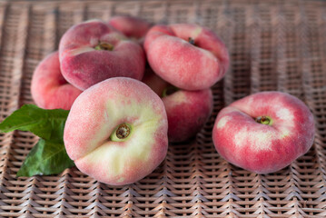 Peaches on a wicker natural background.