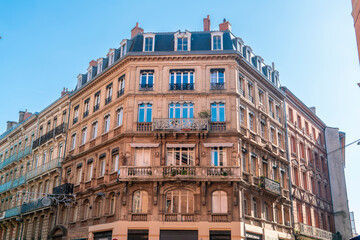 Naklejka premium Facade or exterior of historic traditional houses in red or orange in the old city of Toulouse, France