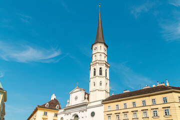 Fototapeta na wymiar St. Michael's Church at Michaelerplatz square with blue sky, Vienna, Austria
