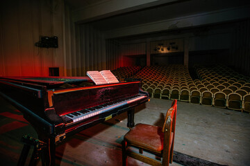 Old piano in abandoned concert hall