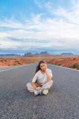 Scenic highway in Monument Valley Tribal Park in Utah. Happy girl on famous road in Monument Valley...