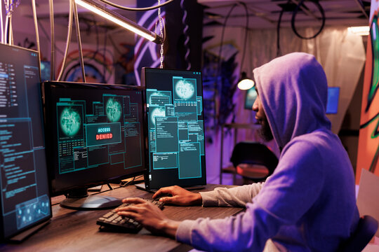 Hacker getting access denied after website password cracking unsuccessful attempt. African american criminal in hood failing cyberattack while breaking into computer system
