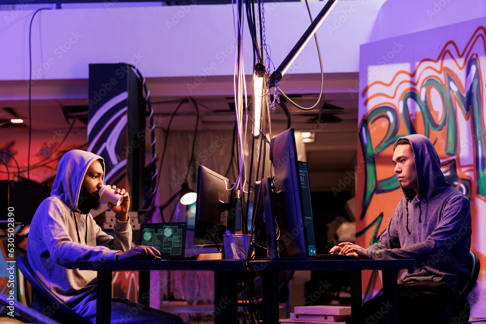 Poster hackers breaking law and doing illegal activity on computer late at night. two young diverse crimina
