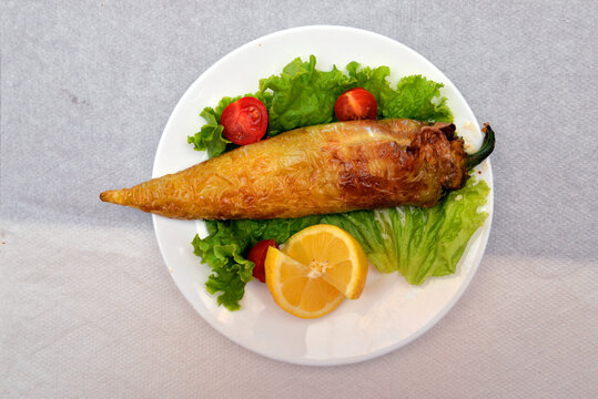 Pepper stuffed with cottage cheese, lemon, lettuce, and cherry tomato, Balkan traditional cuisine