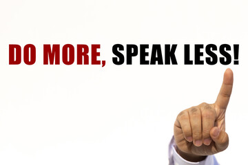 Do more speak less text on white wall background with businessman's finger point at the message with empty space. This message can be used as business concept about taking action.