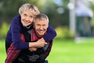 Happy active old couple walking outdoors.