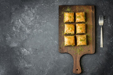 Traditional turkish dessert antep baklava with pistachio on rustic background. Desserts concept