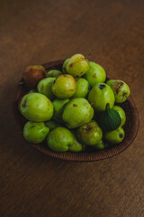 basket full of green apples and one fig from home garden