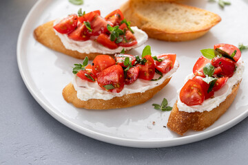 Tomato basil and cream cheese bruschettas with fresh cherry tomatoes