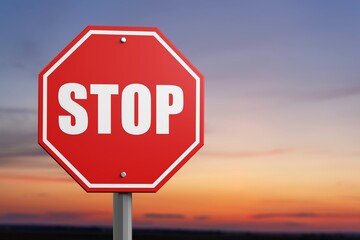A red alarm stop sign at blue sky background