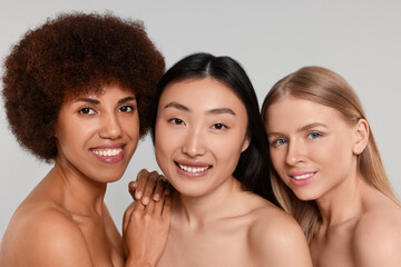 Portrait of beautiful young women on light grey background