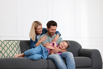 Happy family having fun together on sofa at home