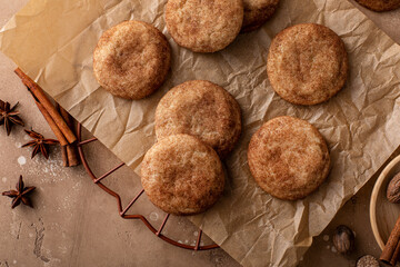 Cinnamon cookies on a parchment paper with milk