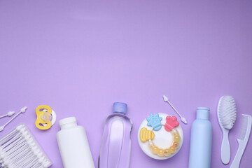 Flat lay composition with baby care products and accessories on lilac background, space for text